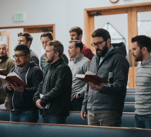 Students signing from hymnals in chapel